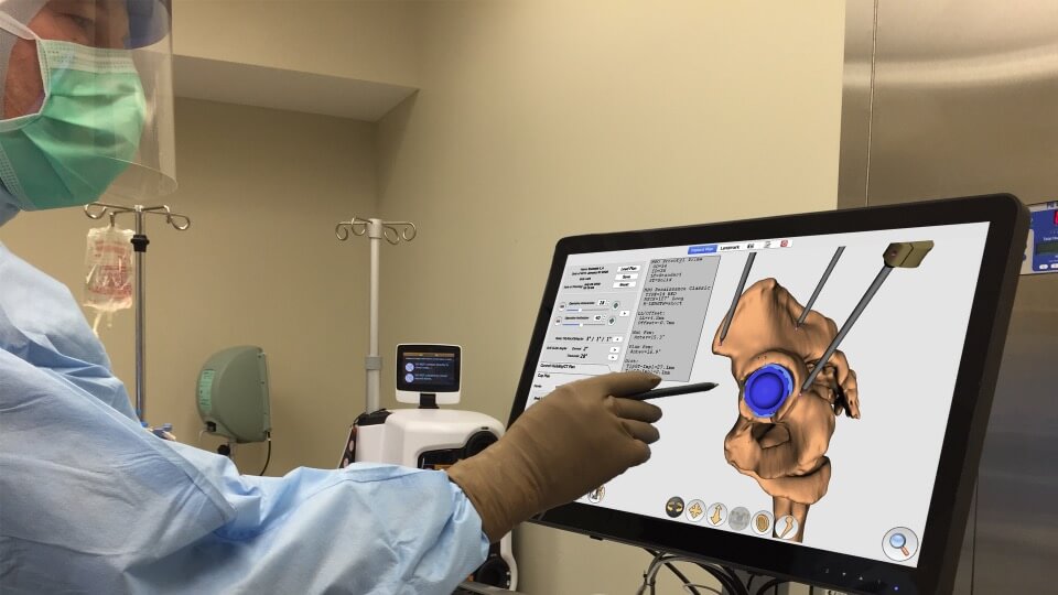 Dr. Murphy Using a Touch Screen Computer While in Surgery